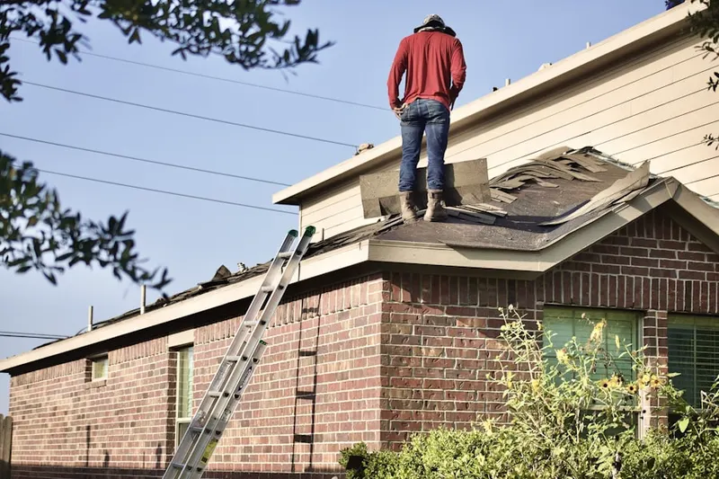 Professional roofer working on a residential roof in Old Orchard Beach